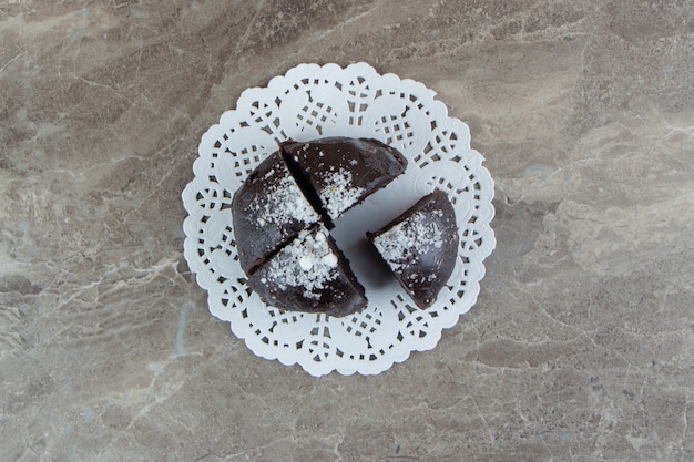 Schokoladenkuchen in vier Stücke auf Marmoroberfläche geteilt