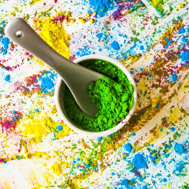 Schüssel mit grüner trockener Farbe zwischen hellen Farben