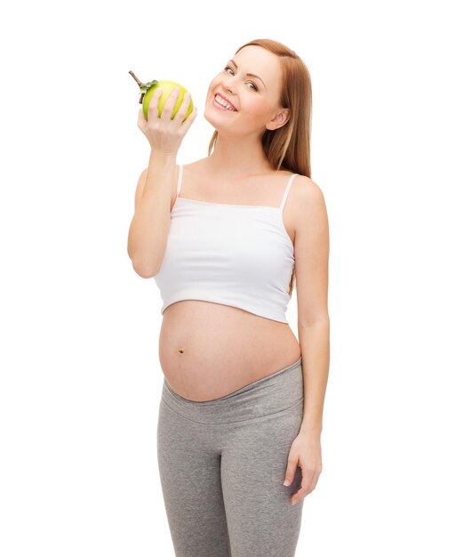 Schwangerschafts-, mutterschafts- und glückskonzept - glückliche zukünftige mutter mit grünem apfel Premium Fotos