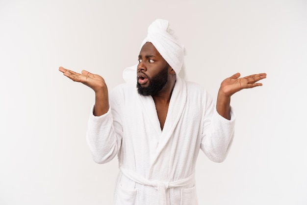 Schwarzer Mann, der einen Bademantel trägt und mit dem Finger zeigt, überrascht und glücklich, isoliert über weißem Hintergrund