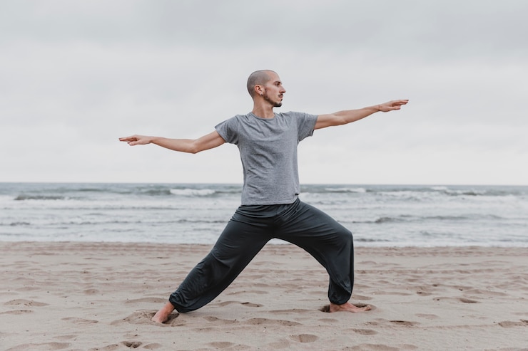 Kostenlose Foto seitenansicht des mannes, der yoga-positionen im freien praktiziert