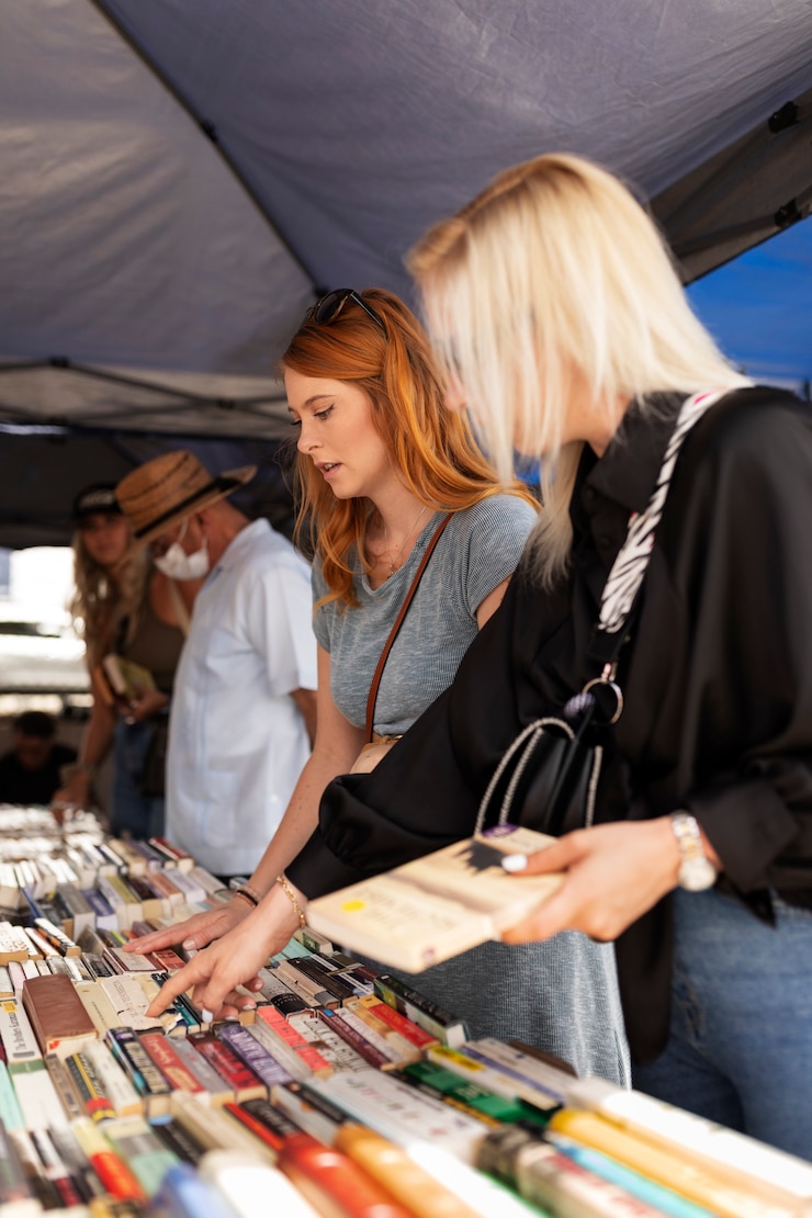 Kostenlose Foto seitenansicht junge leute auf dem flohmarkt