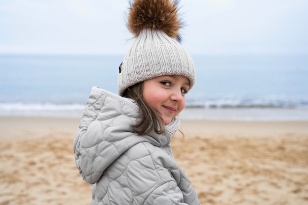 Kostenloses Foto seitenansicht-smiley-kind am meer