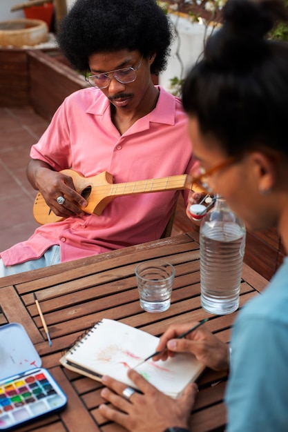 Kostenloses Foto seitenansicht von freunden, die musik machen