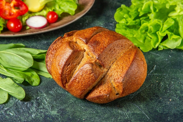 Seitenansicht von frischem gehacktem Schwarzbrotgemüse auf einem Teller und Metergrünbündel auf dunkler Farboberfläche