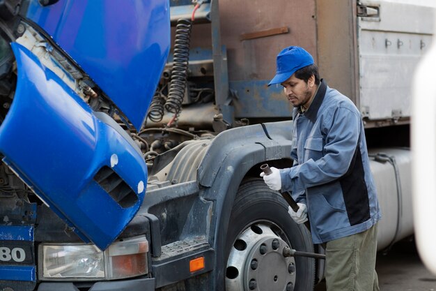 Seitenansichtmechaniker, der LKW überprüft