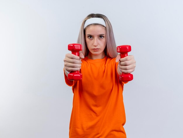 Selbstbewusstes junges kaukasisches sportliches Mädchen mit Zahnspangen, die Stirnband und Armbänder tragen