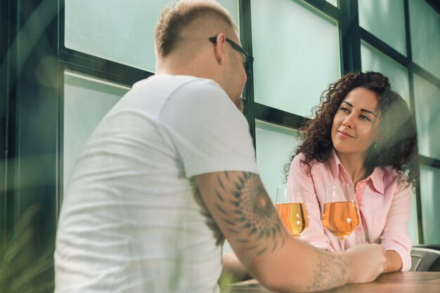 Sie sagte ihm ja. Nahaufnahme des jungen Mannes, der seine Frau Hand küsst, während Heiratsantrag im Freien macht.