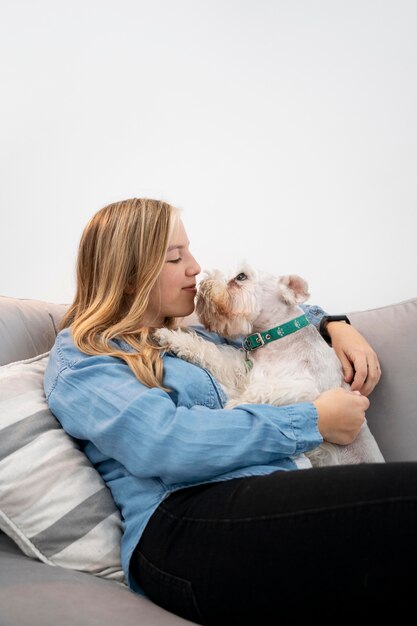 Smiley-Frau mit mittlerem Schuss, die Hund hält