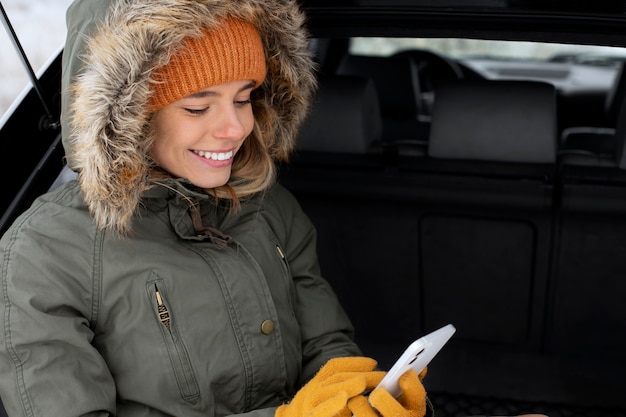 Kostenloses Foto smiley-frau mit mittlerem schuss im auto