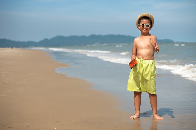 Smiley-Junge der Vorderansicht am Strand