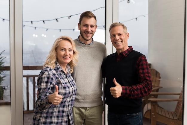 Smileyfamilie, die mit dem Sohn und den Daumen oben aufwirft