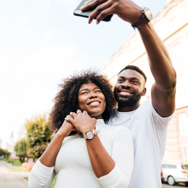 Smileyfreunde, die selfies im Freien nehmen