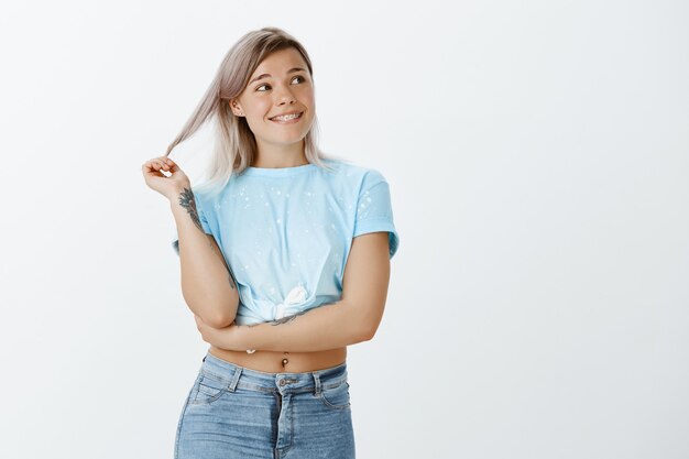 Sorgloses blondes Mädchen, das im Studio aufwirft