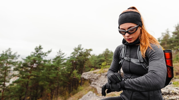 Kostenloses Foto sportliche joggerin der frau, die ihre smartwatch betrachtet