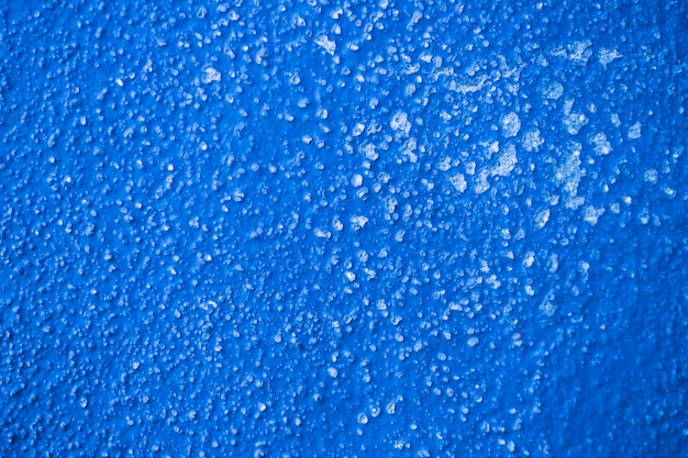 Strukturierter Hintergrund der rauen blauen Wand
