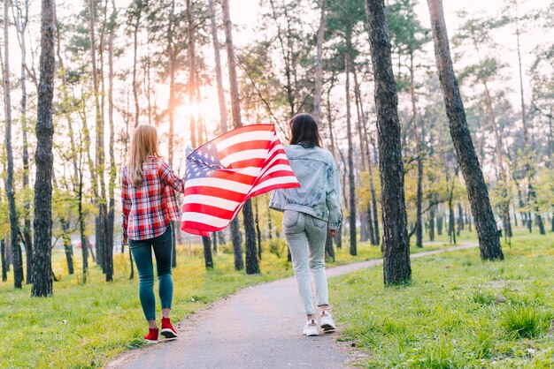 Studentinnen mit Flagge von USA im Park