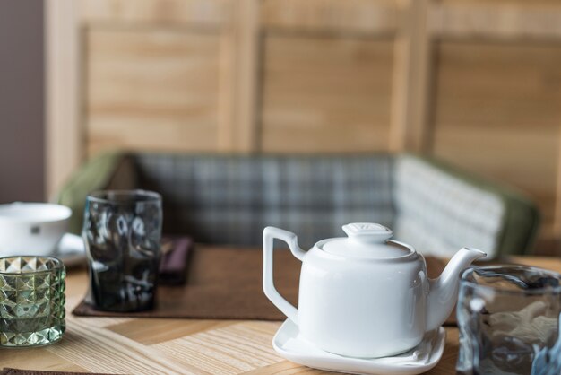 Tabelle mit Teekanne und unscharfem Hintergrund