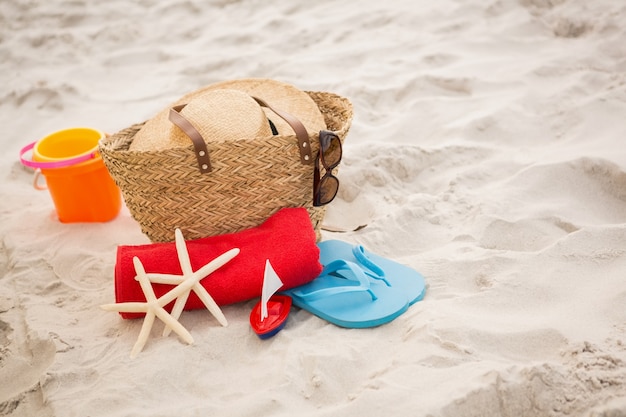 Kostenloses Foto tasche und strand-accessoires auf sand gehalten