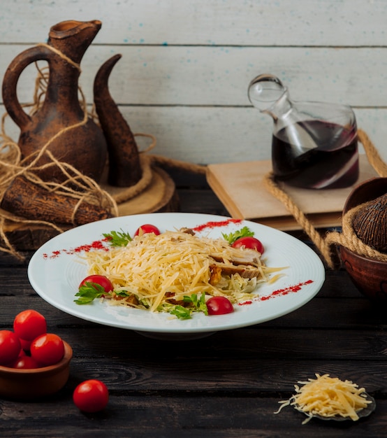 Teller mit hühnchen caesar salat mit geriebenem parmesan an der spitze