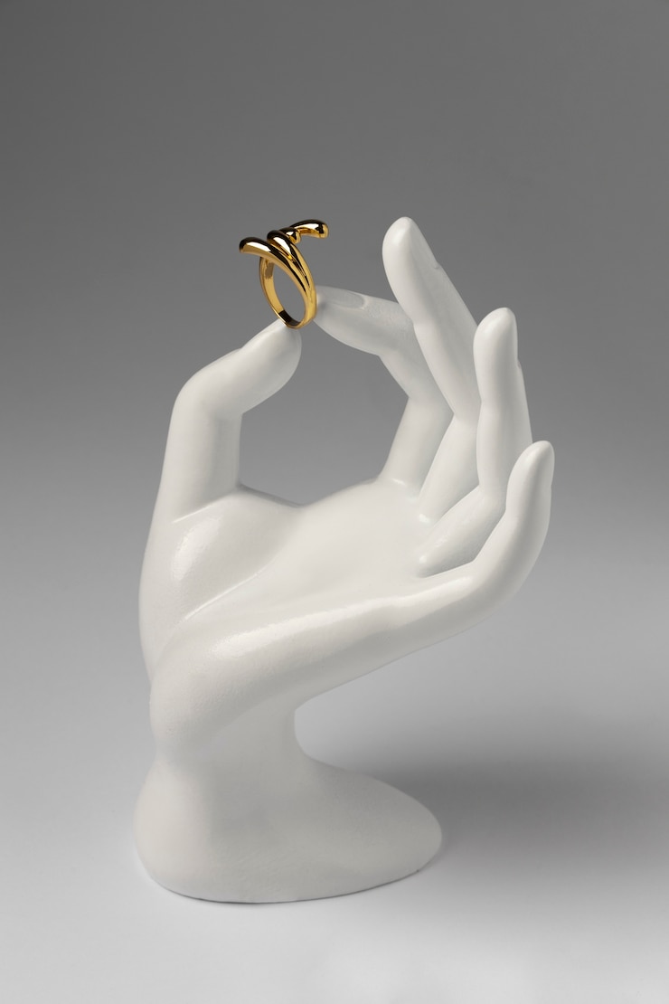 Kostenlose Foto teurer goldener ring mit menschlicher handständeranzeige