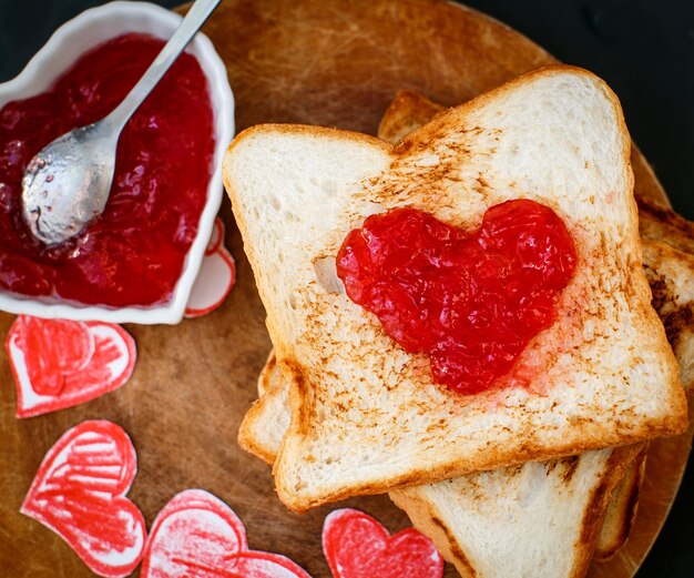 Toast mit Erdbeermarmelade in Herzform Valentinstag