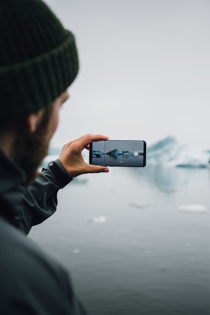 Tourist beobachtet Gletscher im Wasser in Island