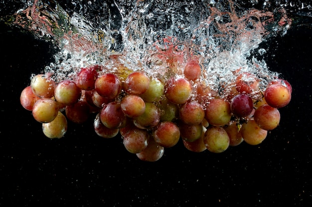 Kostenloses Foto trauben spritzten schwarz ins wasser