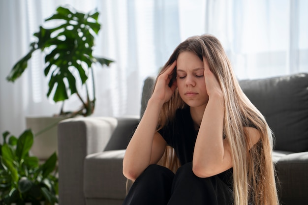 Kostenloses Foto traurige junge frau zu hause