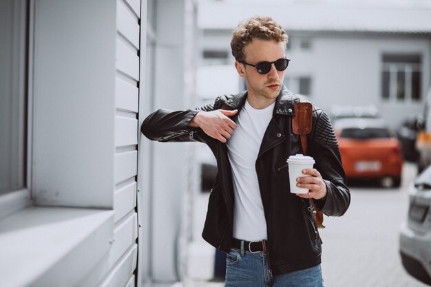 Trinkender Kaffee des jungen gutaussehenden Mannes in der Straße