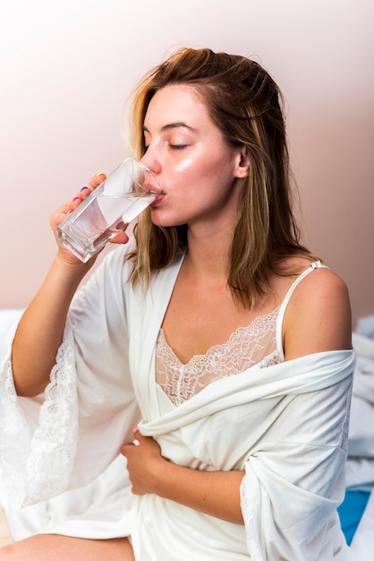 Kostenloses Foto trinkwasser der schönen frau der nahaufnahme in der unterwäsche