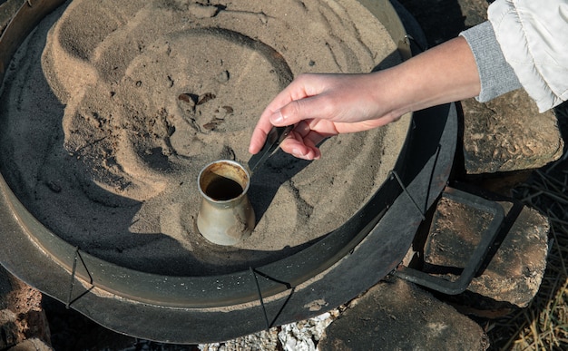 Kostenloses Foto türkischer kaffee zubereitet durch kochen im sand