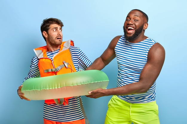 Kostenloses Foto Überglückliche freunde posieren mit strandartikeln