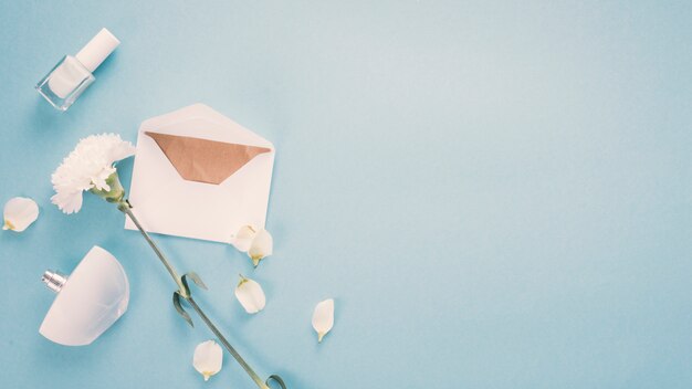 Umschlag mit weißer Blume und Parfüm auf dem Tisch