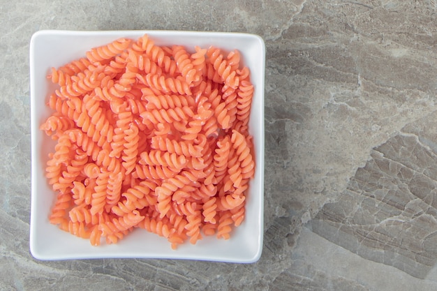 Ungekochte rote Fusilli in weißer Schüssel