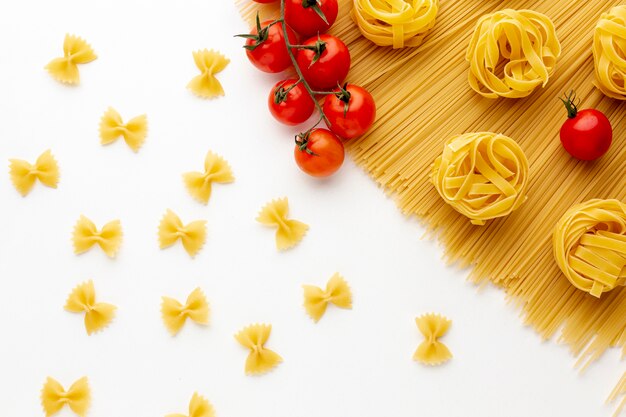 Ungekochte Spaghetti Tagliatelle Farfalle und Tomaten