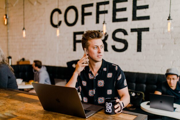 Kostenloses Foto unternehmer, der mit seinem laptop am café arbeitet