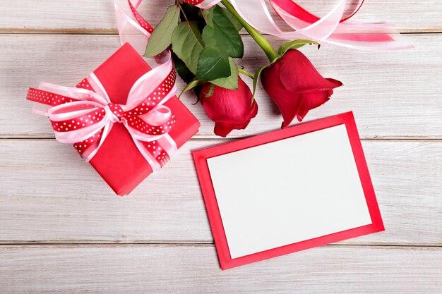 Valentine Geschenk-Box und leere Karte auf einem Holzbrett