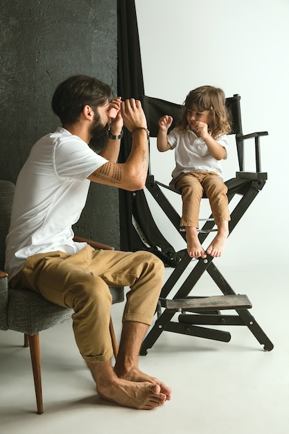 Vater spielt mit dem kleinen Sohn in ihrem Wohnzimmer zu Hause. Junger Vater, der Spaß mit seinen Kindern in den Ferien oder am Wochenende hat