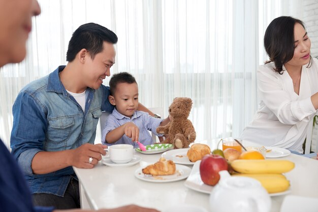 Vater und Sohn beim Frühstück mit der Familie