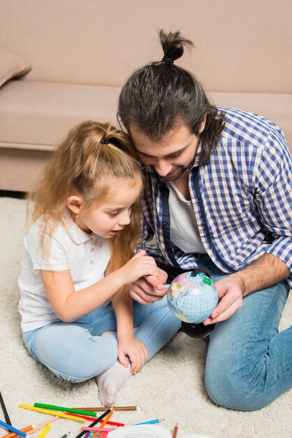 Vater und Tochter, die Kugel betrachten