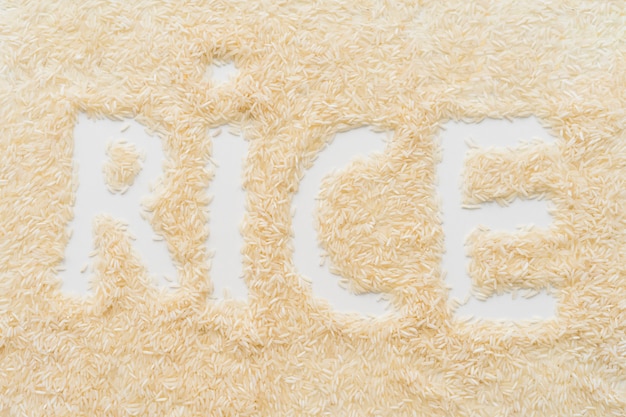 Verbreiten Sie Reis mit Reisworttext über weißem Hintergrund