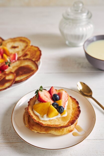 Vertikale Aufnahme von Pfannkuchen mit Früchten auf der Oberseite