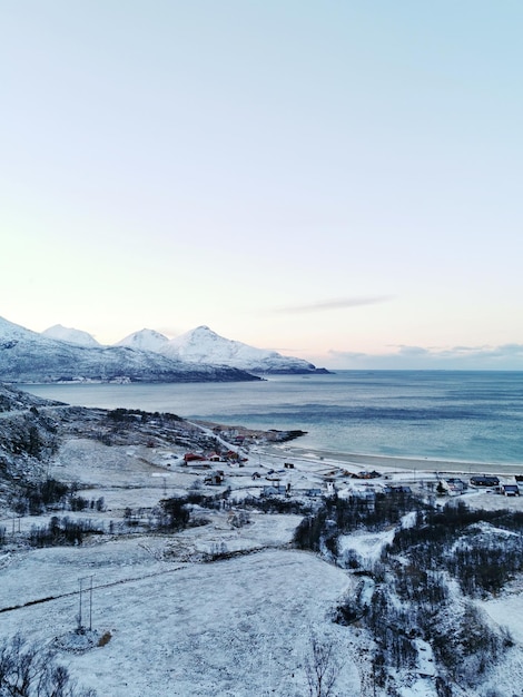 Vertikale aufnahme von schneebedeckten bergen und landschaften auf der insel kvaloya in norwegen