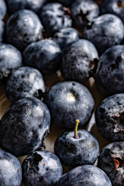 Vertikale Nahaufnahme köstlicher Blaubeeren auf einer Oberfläche