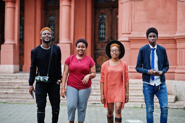 Vier afrikanische Freunde, die Spaß im Freien haben Zwei schwarze Mädchen mit Jungs