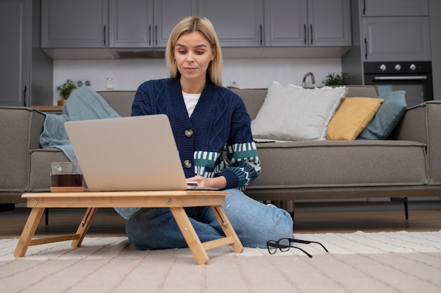 Voll erschossene Frau, die am Laptop arbeitet