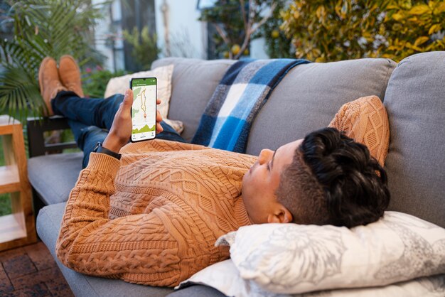 Kostenloses Foto vollbildaufnahme eines mannes, der sein smartphone im freien nutzt