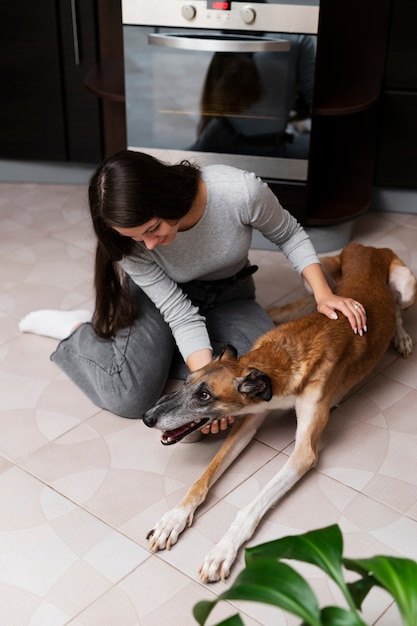 Kostenloses Foto volle aufnahme frau, die smiley-hund streichelt