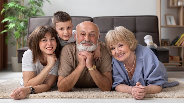 Volle Schuss glückliche Familie, die auf Boden aufwirft